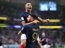 France's forward #09 Olivier Giroud celebrates with France's forward #10 Kylian Mbappe (top) after scoring his team's first goal during the Qatar 2022 World Cup round of 16 football match between France and Poland at the Al-Thumama Stadium in Doha on December 4, 2022. (Photo by Kirill KUDRYAVTSEV / AFP)