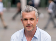 Portrait of a handsome business man looking at the camera on the street