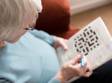 Senior Woman Doing Crossword Puzzle At Home