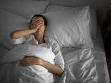 Woman feeling sick and tired in the bed.