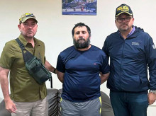 This handout picture released by the Ecuadorean Army shows drug trafficker Adolfo Macias (C), alias Fito, being guarded by Ecuador's Defense Minister Gian Carlo Loffredo (L) and Ecuador's Interior Minister John Reimberg after his recapture in Manta, Manabi Province, Ecuador, on June 25, 2025. Ecuadorian security forces recaptured fugitive "Fito," the country's most wanted drug trafficker, whose escape in January 2024 sparked an unprecedented wave of violence, President Daniel Noboa reported on June 25. (Photo by Handout / Ecuadorean Army / AFP) / RESTRICTED TO EDITORIAL USE - MANDATORY CREDIT "AFP PHOTO / ECUADOREAN ARMY" - NO MARKETING NO ADVERTISING CAMPAIGNS - DISTRIBUTED AS A SERVICE TO CLIENTS