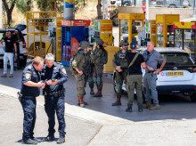 Israeli security forces gather at a petrol station following a suspected shooting attack near the town of Kokhav Yair in central Israel close to the occupied West Bank on June 7, 2026. One person was killed and four others wounded in multiple suspected shooting attacks in Israel on June 7, rescuers and the army said. (Photo by Jack GUEZ / AFP)