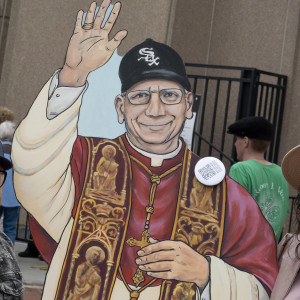 CHICAGO, ILLINOIS - JUNE 14: Graciela Beruben Stan poses with a cutout of Pope Leo XIV as she arrives at Rate Field, home to the Chicago White Sox, for a celebration and mass to honor the election of Pope Leo XIV on June 14, 2025 in Chicago, Illinois. Born Robert Prevost in Chicago and raised in nearby south suburban Dolton, Pope Leo XIV is the first American leader of the Catholic Church. He is also a Chicago White Sox baseball fan.   Scott Olson/Getty Images/AFP (Photo by SCOTT OLSON / GETTY IMAGES NORTH AMERICA / Getty Images via AFP)