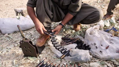 A Kurdistan PKK fighter prepares bullets of ''Dorcka'' early in the morning 20 June 2007 before a training session at Amedia area in Northern Iraq, 10 km near Turkish border. Turkey declared several areas near the border with Iraq to be 'temporary security zones' in a sign of increasing activity in its campaign against Kurdish rebels. AFP PHOTO/MUSTAFA OZER (Photo by MUSTAFA OZER / AFP)