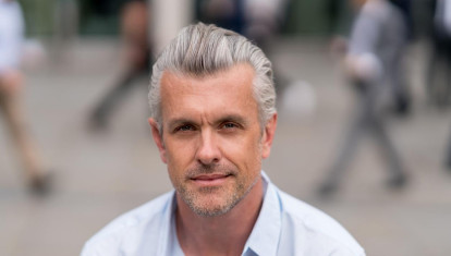 Portrait of a handsome business man looking at the camera on the street