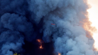 A firefighting helicopter attempts to extinguish a fire at the Russian e-commerce firm Wildberries' logistics complexes in the town of Elektrostal outside Moscow on July 18, 2026. A Ukrainian drone attack on two logistics centres in Russia killed eight people and injured 24, officials said on July 18, 2026, when the Moscow region reported a new wave of drone strikes. Russian e-commerce firm Wildberries said its logistics complexes in Kotovsk and Elektrostal, in the Tambov and Moscow regions respectively, came under attack. One person was killed and 37 were injured at the Elektrostal warehouse, according to the region's governor, Andrei Vorobyov. (Photo by TATYANA MAKEYEVA / AFP)