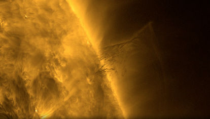 Primer plano del Sol, que ocupa la mitad izquierda de la imagen. A la derecha, en el centro del video, sobresale un material oscuro
