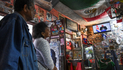 A woman listens to Cuba's President Miguel Diaz-Canel speaking on the National Television, at a store in Havana on February 5, 2026. Cuba is prepared to hold dialogue with the United States but not under pressure, President Miguel Diaz-Canel insisted Thursday after months of threats from US President Donald Trump. (Photo by YAMIL LAGE / AFP)