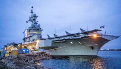 The colors of the tricolor illuminate the tower with the bridge as the French aircraft carrier Charles De Gaulle (R91) was shown to the media and invited guests on Wednesday where it is docked at the North Port in Malmö, Sweden, on February 25, 2026. 
Photo: Johan Nilsson / TT / Code 50090 (Photo by JOHAN NILSSON / TT News Agency via AFP)