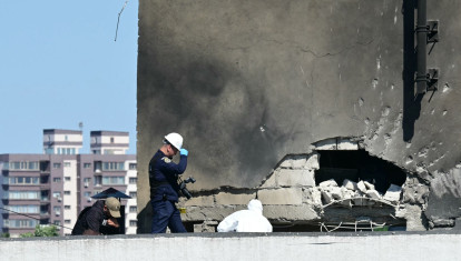 La Policía y los investigadores forenses examinan el lugar del impacto tras el choque de un dron ruso contra un edificio de apartamentos en Galati, al este de Rumania