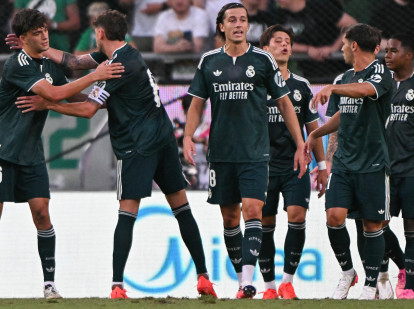 Real Madrid's Spanish defender #36 Mario Rivas (L) celebrates scoring with his team-mates during the pre-season football match between Ferencvaros and Real Madrid in Budapest, Hungary on August 8, 2026. Real Madrid on August 6, 2026 announced a new six-year deal for star forward Vinicius Junior and the signing of teenage sensation Yan Diomande in a major boost to their quest to end a two-year trophy drought. (Photo by Attila KISBENEDEK / AFP)