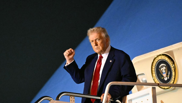 US President Donald Trump pumps his fist as he steps off Air Force One upon arrival at Palm Beach International Airport in West Palm Beach, Florida on April 3, 2025. Trump is heading to his Mar-a-Lago resort. (Photo by Mandel NGAN / AFP)