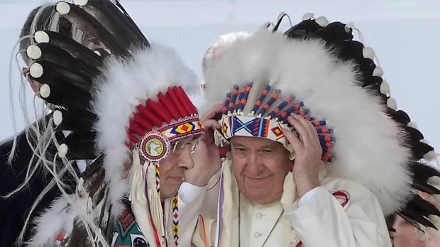 Pope Francis with a traditional headdress during a ceremony in Maskwacis, Alberta, as part of his papal visit across Canada on Monday, July 25, 2022.