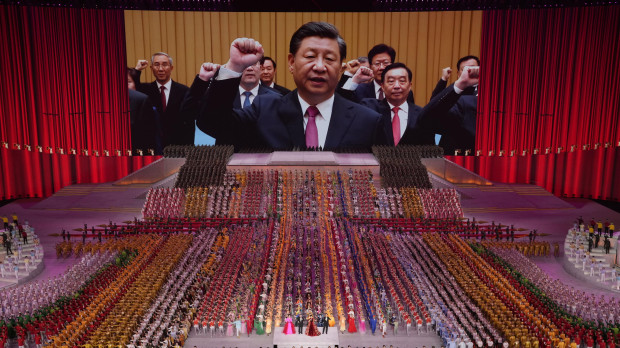 FILE - Chinese President Xi Jinping is seen leading other top officials pledging their vows to the party on screen during a gala show ahead of the 100th anniversary of the founding of the Chinese Communist Party in Beijing, June 28, 2021. Xi was dubbed "chairman of everything" after he put himself in charge of economic, propaganda and other major functions. That reversed a consensus for the ruling inner circle to avoid power struggles by sharing decision-making. (AP Photo/Ng Han Guan, File) China