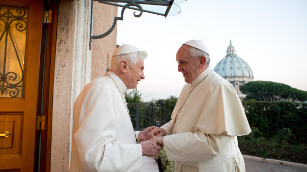 Pope Emeritus Benedict XVI, left, welcomes Pope Francis greetings, at the Vatican, Monday, Dec. 23, 2013.