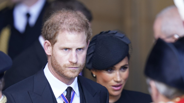 Britain's Prince Harry and Meghan Markle , Duchess of Sussex during transfer of Queen Elizabeth II's remains from BuckinghamPalace to WestminsterHall, London on September 14, 2022.