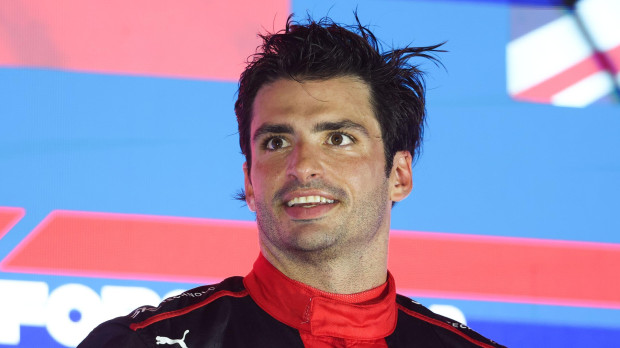 Ferrari's Carlos Sainz Jr. celebrates after winning the Formula One F1 - Singapore Grand Prix - Marina Bay Street Circuit, Singapore - September 17, 2023