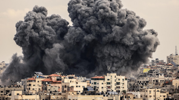 A plume of smoke rises in the sky of Gaza City during an Israeli airstrike on October 9, 2023. - Israel relentlessly pounded the Gaza Strip overnight and into October 9 as fighting with Hamas continued around the Gaza Strip, as the death toll from the war against the Palestinian militants surged above 1,100. (Photo by MAHMUD HAMS / AFP)
