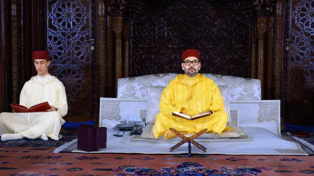 King Mohammed VI of Morocco (centre), and his son Crown Prince Moulay Hassan (or El Hassan, left, pray during a religious vigil at the Mohammed V Mausoleum in Rabat, Morocco, on October 25, 2023, in commemoration of the 25th year of the passing away of the late King Hassan II, The 25th year should be in July 2024, but this is now the