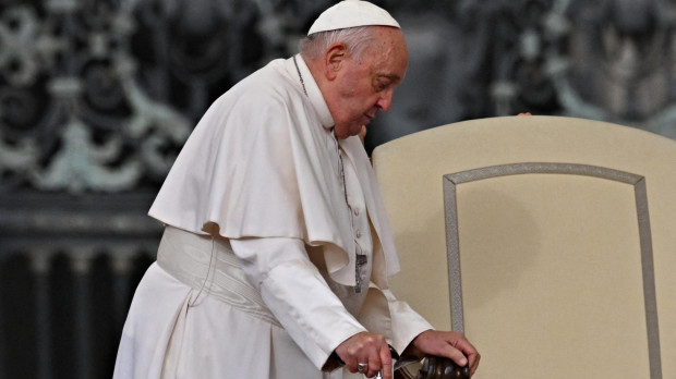 Pope Francis using a walking stick arrives for the weekly general audience at Saint Peter's Square in The Vatican on October 16, 2024. (Photo by Andreas SOLARO / AFP)