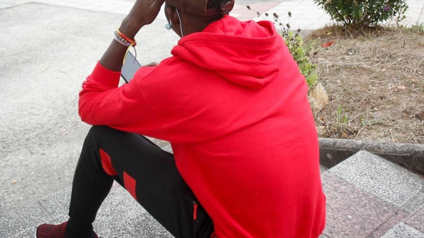Un inmigrante sentado en la calle, a 20 de septiembre de 2024, en Monterroso, Lugo, Galicia (España)