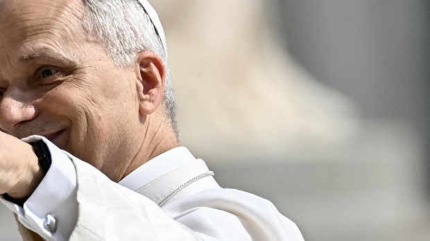 Pope Leo XIV waves to the crowd as he arrives to hold the weekly general audience in St Peter's Square at the Vatican, on June 11, 2025. (Photo by Filippo MONTEFORTE / AFP)