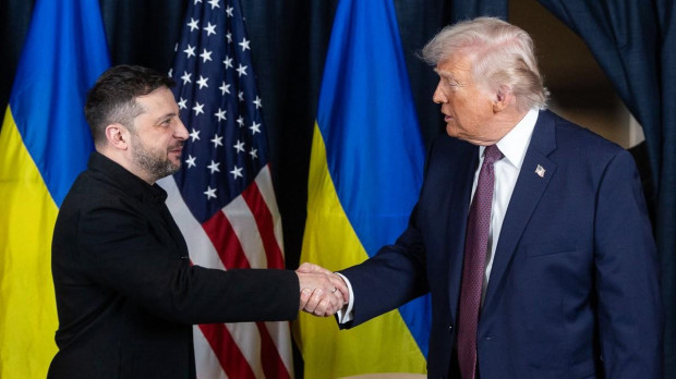 A picture obtained from the X account of Volodymyr Zelensky on January 22, 2026, shows Ukraine's President Volodymyr Zelensky (L) and US President Donald Trump shaking hands during their bilateral meeting on the sidelines of the World Economic Forum (WEF) annual meeting in Davos. (Photo by Handout / X account of Volodymyr Zelensky / AFP) / RESTRICTED TO EDITORIAL USE - MANDATORY CREDIT