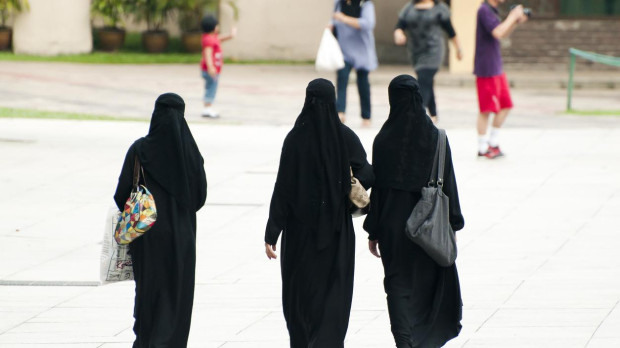 Kuala Lumpur, Malaysia - November 26, 2010: Local women dressed in a religious burka