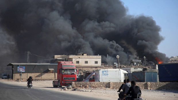 Smoke billows from a warehouse after reported shelling on the town of Sarmada in Syria's northwestern Idlib province on October 16, 2021. (Photo by Aaref WATAD / AFP)