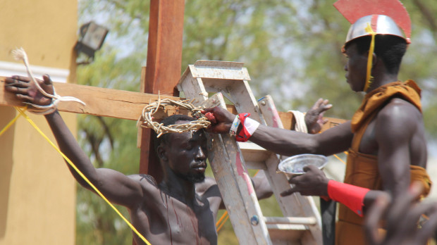 An unidentified South Sudanese dressed as Jesus Christ re-enacts the story of the crucifixion of Jesus Christ, during a procession to mark Good Friday in Juba, South Sudan, Friday, April 14, 2017