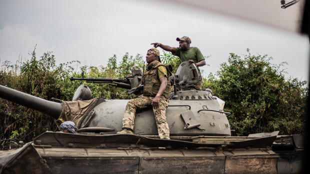 Soldiers of the Armed forces of the Democratic republic of Congo (FARDC) gesture as they ride on top of a tank as they advance towards Sake, 25km north west of Goma on January 23, 2025. A barren plain surrounded by volcanic peaks and where shelters are rare: in this lunar landscape, the Congolese army is fighting to halt the advance of the M23 towards Goma, a city in the east of the Democratic Republic of Congo. (Photo by Jospin Mwisha / AFP)
