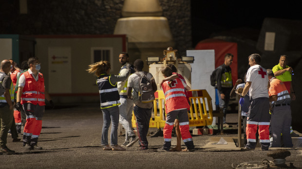 Imagen de trabajadores de la Cruz Roja recibiendo inmigrantes en una patera en El Hierro, Canarias