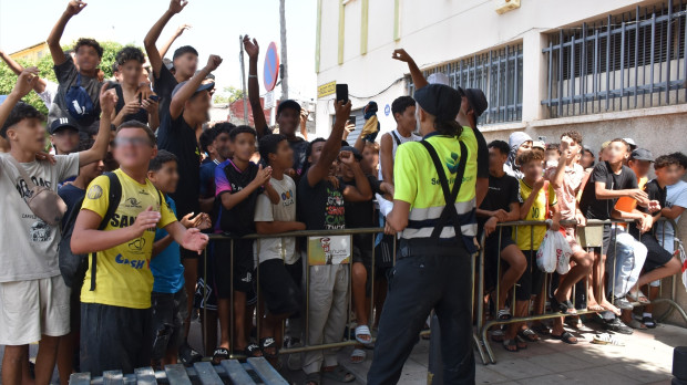 Un grupo de menores espera para ser filiado en una comisaría de la Policía Nacional, a 10 de agosto de 2026, en Ceuta (España)