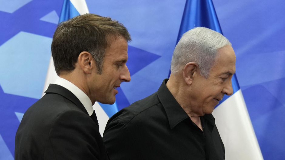 Israeli Prime Minister Benjamin Netanyahu (R) greets French President Emmanuel Macron before a meeting in Jerusalem on October 24, 2023. Macron's visit comes more than two weeks after Hamas militants stormed into Israel from the Gaza Strip and killed at least 1,400 people, according to Israeli officials while Israel continues a relentless bombardment of the Gaza Strip and prepares for a ground offensive with more than 5,000 Palestinians, mainly civilians, killed so far across the Palestinian territory, according to the latest toll from the Hamas health ministry in Gaza. (Photo by Christophe Ena / POOL / AFP)