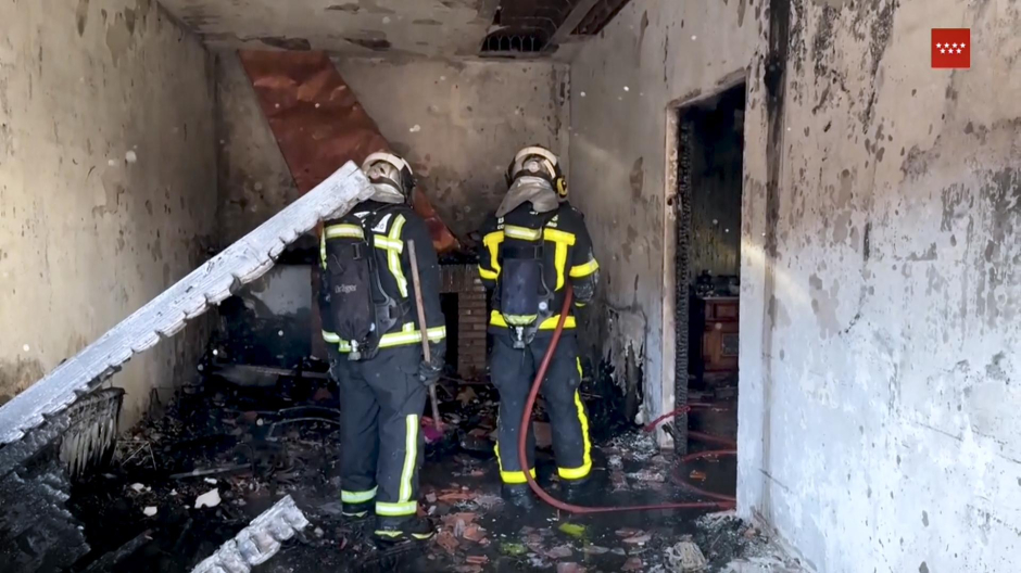 Bomberos de la Comunidad de Madrid apagando el fuego de la vivienda afectada