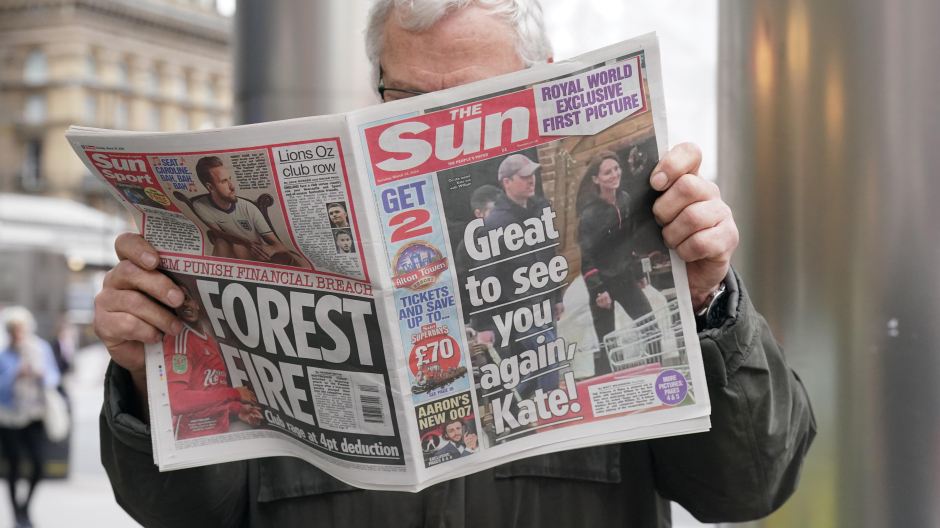 A man reads a copy of The Sun newspaper in central London which shows the Princess of Wales with the Prince of Wales during a visit to a farm shop in Windsor. Picture date: Tuesday March 19, 2024.