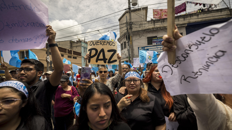 Manifestantes sostienen carteles durante una protesta frente a la sede del Ministerio Público