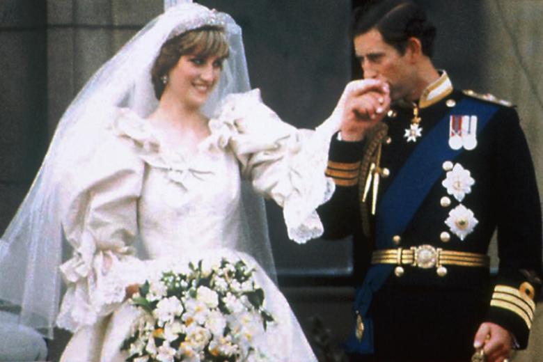 Prince Charles kisses the hand of his bride Princess Diana on the balcony of Buckingham Palace on their wedding day in London, England,  July 29, 1981.