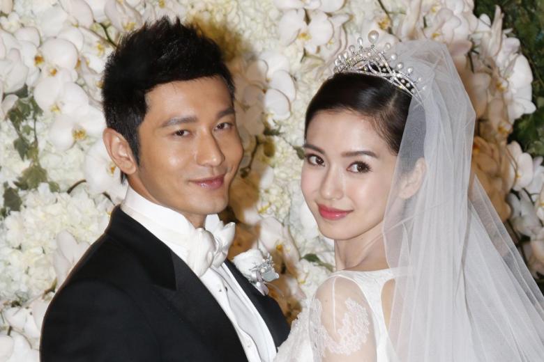 Chinese actor Huang Xiaoming, left, and his actress wife Angelababy pose during their wedding ceremony at the Shanghai Exhibition Center in Shanghai, China, 8 October 2015.