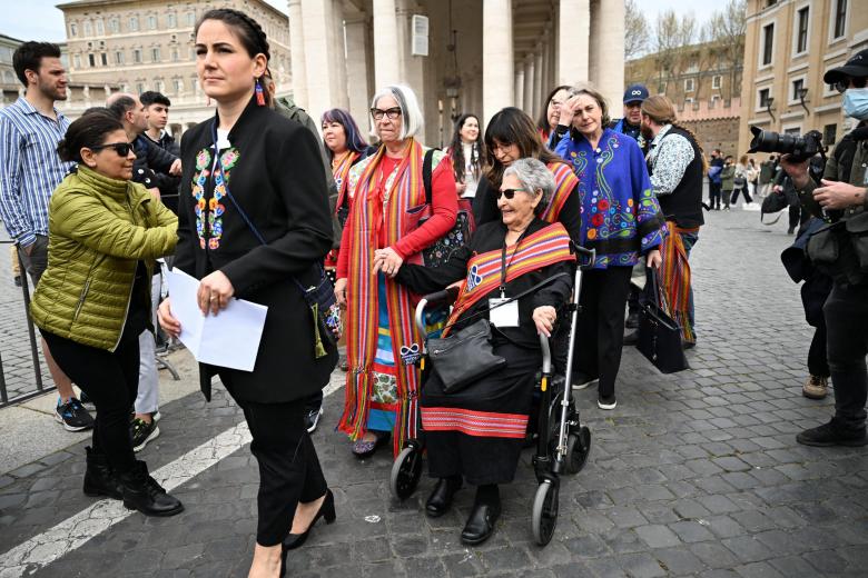 Canada's Metis National Council President, Cassidy Caron (C), escorted by delegations members, addresses the media on March 28, 2022 at St. Peter's square in The Vatican, following a meeting with the Pope, as part of a series of a week-long meetings of Canada's Indigenous elders, leaders, survivors and youth at the Vatican. (Photo by Andreas SOLARO / AFP)