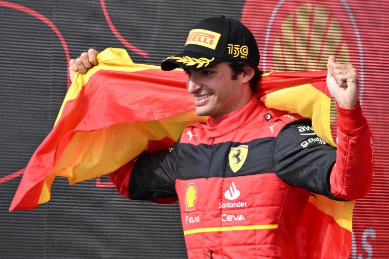 Carlos Sainz, engalanado con la bandera de España, celebra su victoria en Silverstone