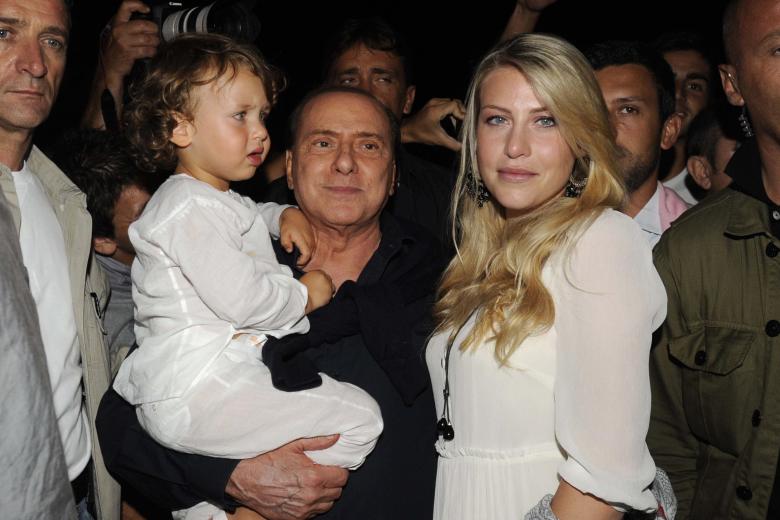Silvio Berlusconi carga a su nieto Alessandro junto a su hija Barbara en una calle de Porto Rotondo, Italia en 2010