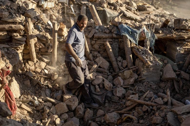 A man rescues a donkey trapped under rubble after an earthquake in the mountain village of Tafeghaghte, southwest of the city of Marrakesh, on September 9, 2023. - Morocco's deadliest earthquake in decades has killed more than 1,300 people, authorities said on September 9, as troops and emergency services scrambled to reach remote mountain villages where casualties are still feared trapped. (Photo by FADEL SENNA / AFP)