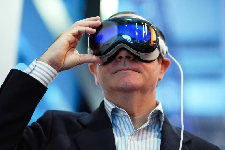 A man uses Apple Vision Pro mixed reality glasses device by US company Apple Inc. at the Mobile World Congress (MWC), the telecom industry's biggest annual gathering, in Barcelona on February 27, 2024. The world's biggest mobile phone fair throws open its doors in Barcelona with the sector looking to artificial intelligence to try and reverse declining sales. (Photo by PAU BARRENA / AFP)