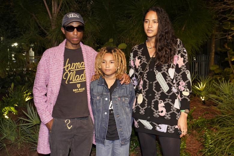 Pharrell Williams, left, and his his wife Helen Lasichanh, right, arrive with their son Rocket Ayer for an event celebrating 100 years of the fragrance Chanel No. 5 during Miami Art Week, Friday, Dec. 3, 2021, in the Design District neighborhood of Miami. Artist Es Devlin was commissioned by Chanel to create an installation titled "Five Echoes" for the celebration. Miami Art Week is an annual event centered around the Art Basel Miami Beach fair.