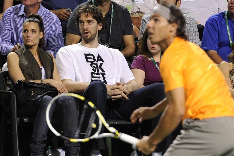 Pau Gasol, right, of Spain, and Silvia Lopez Castro watch Rafael Nadal at the BNP Paribas Open tennis tournament, Tuesday, March 15, 2011, in Indian Wells, Calif.