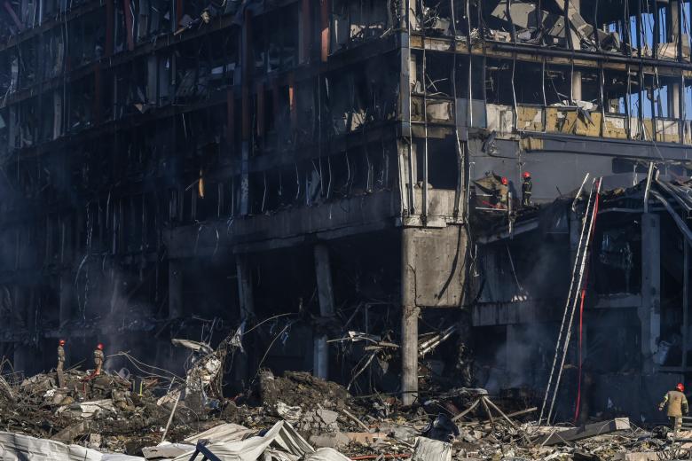 Los bomberos trabajan en la escena del destruido centro comercial Retroville tras el bombardeo ruso