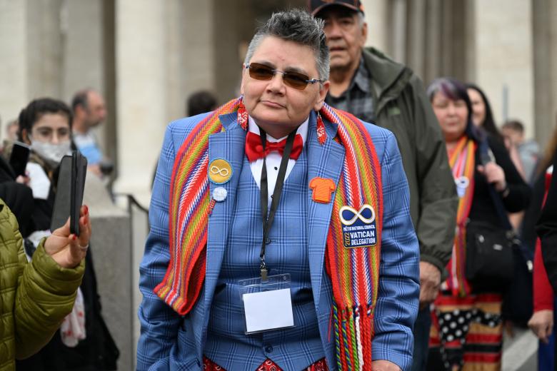 Canada's Metis National Council President, Cassidy Caron (4th R with embroidered jacket), escorted by delegations representatives members, poses within an addres to the media on March 28, 2022 at St. Peter's square in The Vatican, following a meeting with the Pope, as part of a series of a week-long meetings of Canada's Indigenous elders, leaders, survivors and youth at the Vatican. (Photo by Andreas SOLARO / AFP)