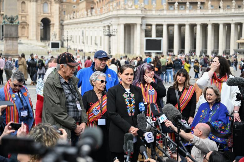 Canada's Metis National Council President, Cassidy Caron (C), escorted by delegations members, addresses the media on March 28, 2022 at St. Peter's square in The Vatican, following a meeting with the Pope, as part of a series of a week-long meetings of Canada's Indigenous elders, leaders, survivors and youth at the Vatican. (Photo by Andreas SOLARO / AFP)