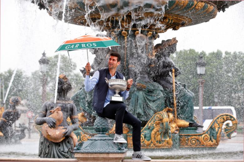 Novak Djokovic  poses with his Australian Open trophy in the men's singles final at the Australian Open tennis championship in Melbourne, Australia, Monday, Feb. 2, 2015.